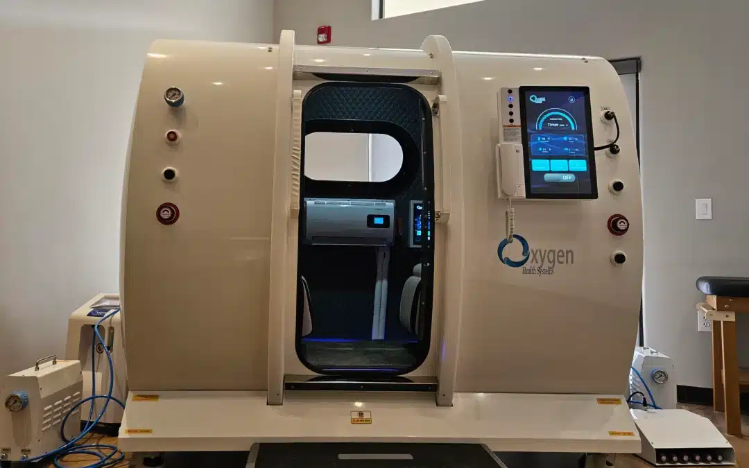 Open MRI scanner with beige gantry, blue cushioned inner surface, and a touchscreen control panel on the right side displaying settings.